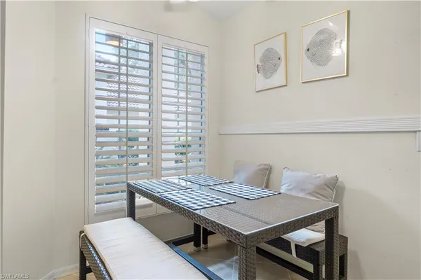 a view of a room that has a table and chairs in it