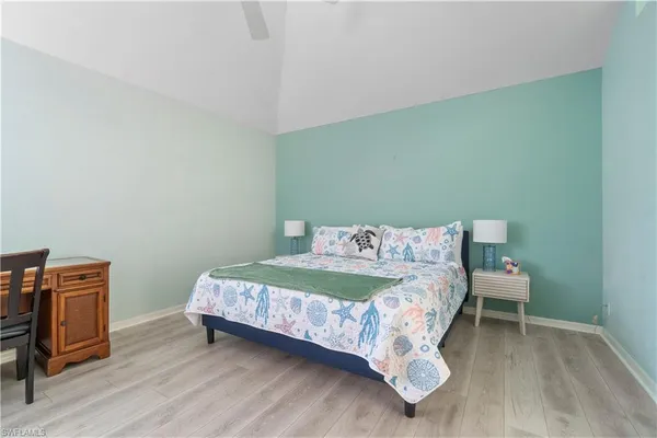 a bedroom with a bed and a chair