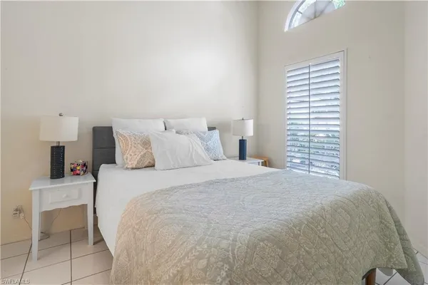 a bedroom with a bed and chair