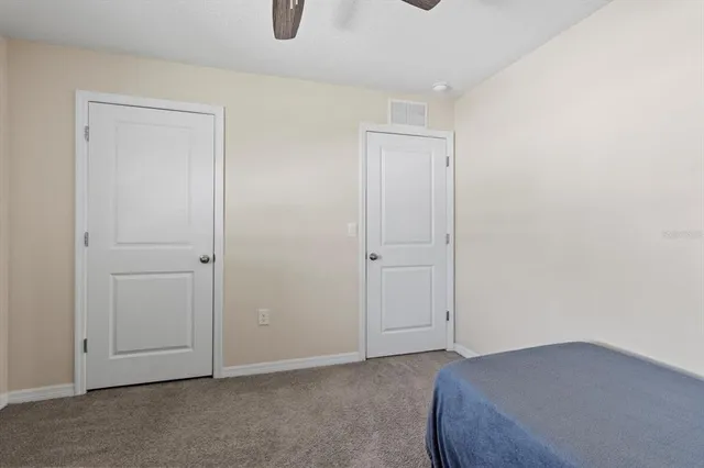 a view of a patio with table and chairs under an umbrella