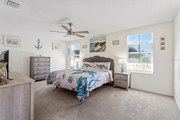 a bedroom with a bed a dresser and a window