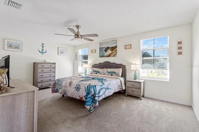 a bedroom with a bed a dresser and a window