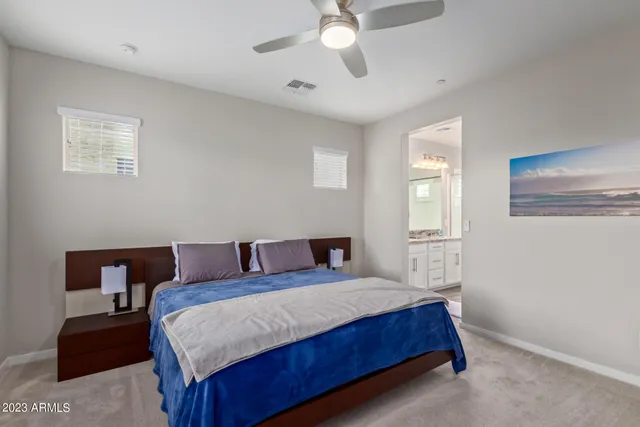 a bedroom with a bed couch and window