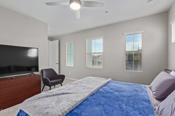 a bedroom with furniture and a flat screen tv
