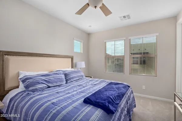 a bedroom with a large bed and a window