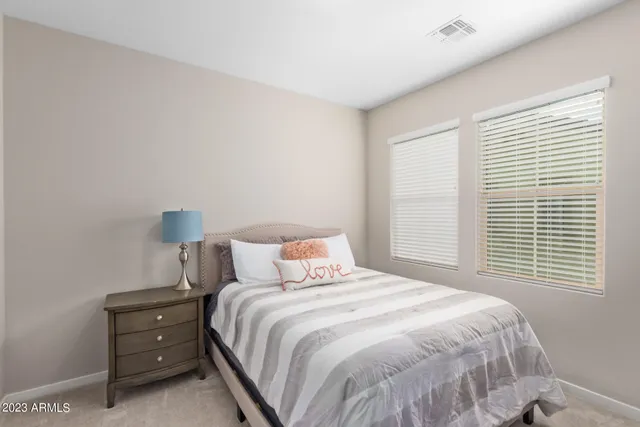 a bedroom with a bed and a night stand