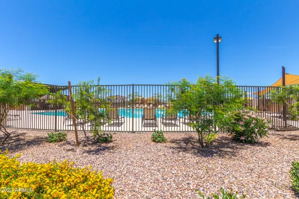 a view of a house with a yard and fence