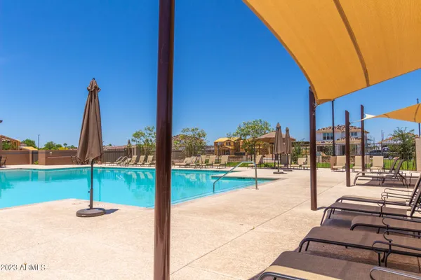 a view of a patio with a table and chairs