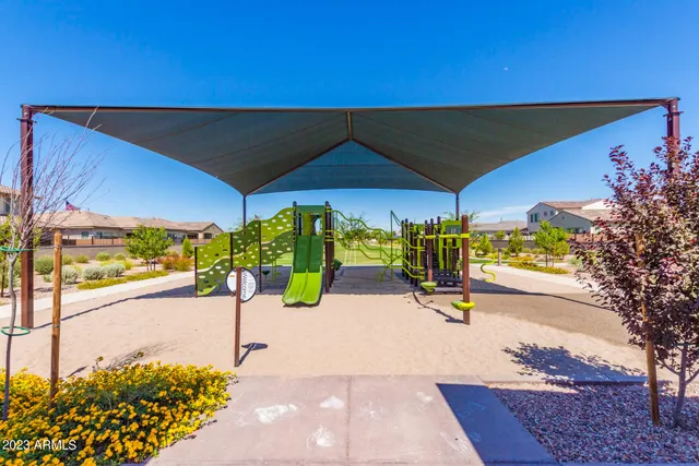 a view of a street with tables and chairs