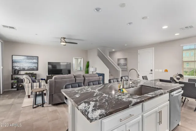 a kitchen with stainless steel appliances granite countertop a sink a stove and a refrigerator