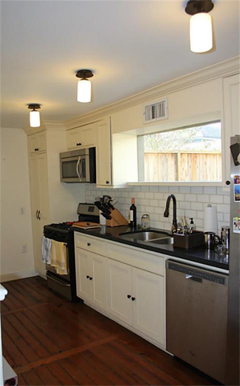 1609 1/2 Kipling Street Houston, TX 77006 - Photo 2 of 11 7x17 SF kitchen has double sink, granite counter tops, and view of the semi-enclosed yard.