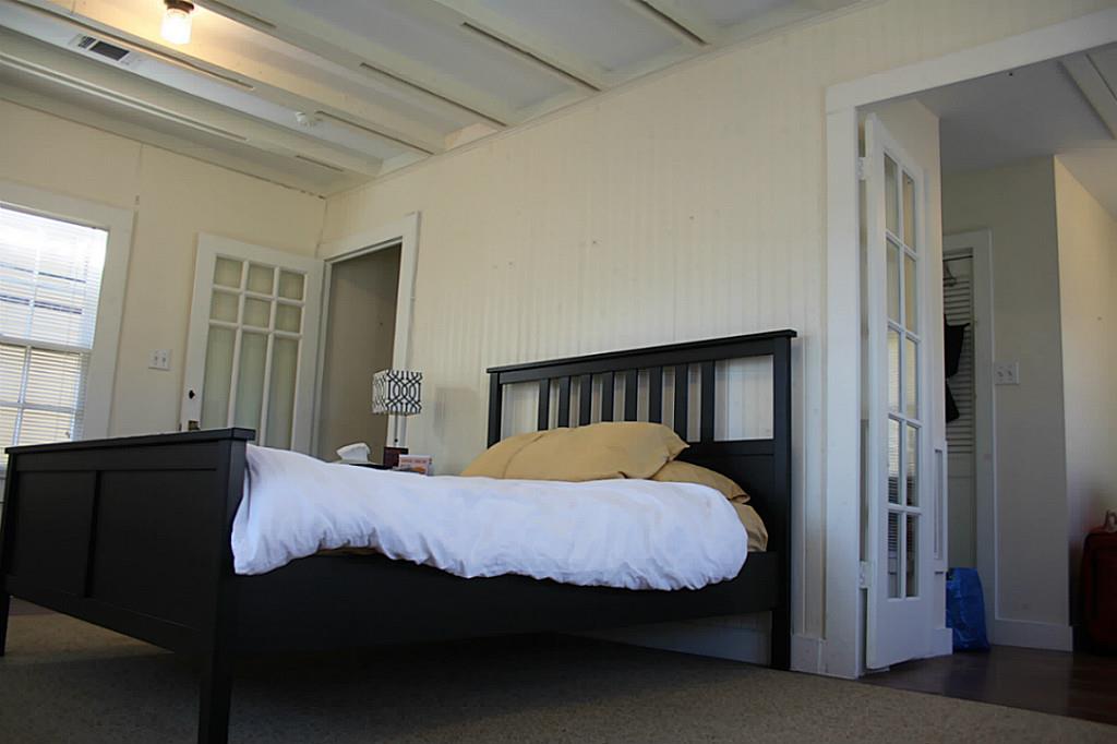 1609 1/2 Kipling Street Houston, TX 77006 - Photo 9 of 11 Exposed beams, vintage light fixtures, and decorative glass doors all lend to the charm of this home.