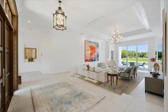 a living room with furniture garden view and large window