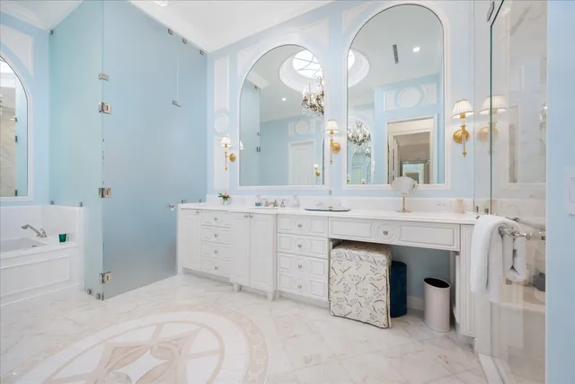 a vase of flowers sitting on a table with chandelier