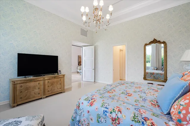 a spacious bedroom with a bed and a flat screen tv in it