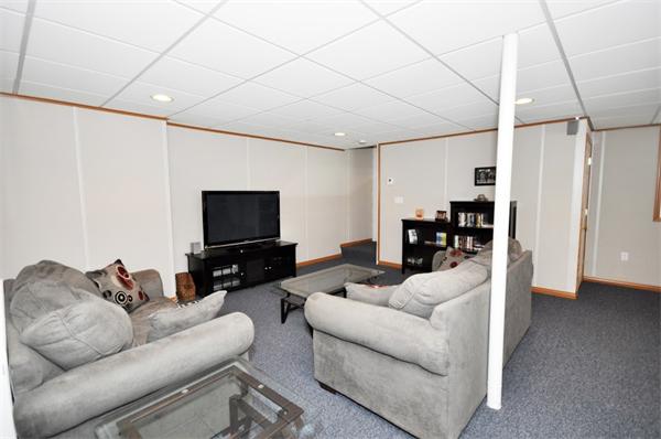 113 Acton Street Maynard, MA 01754 - Photo 12 of 20 a living room with furniture and a flat screen tv