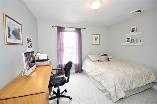 113 Acton Street Maynard, MA 01754 - Photo 16 of 20 a bedroom with a bed and chair