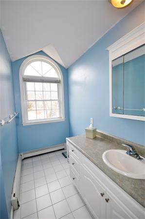 113 Acton Street Maynard, MA 01754 - Photo 18 of 20 a bathroom with a sink a vanity and a mirror