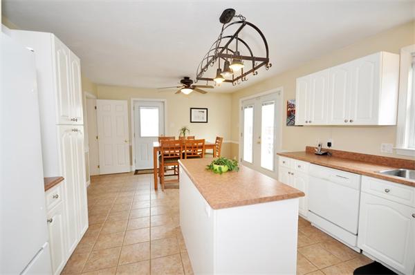 113 Acton Street Maynard, MA 01754 - Photo 7 of 20 a large kitchen with a large counter top space appliances and cabinets