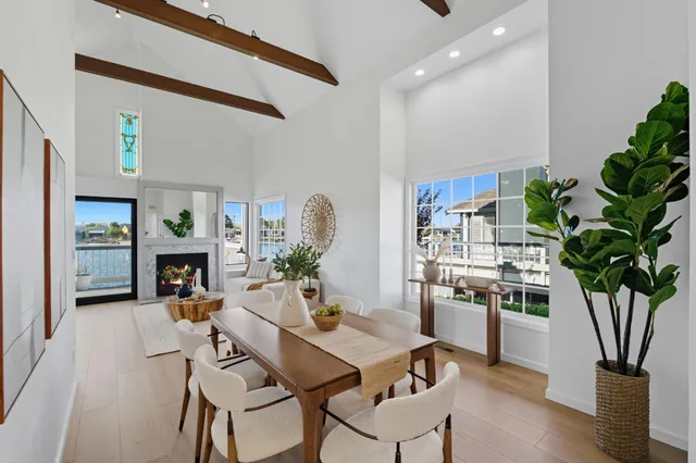 a living room with furniture a fireplace and a potted plant