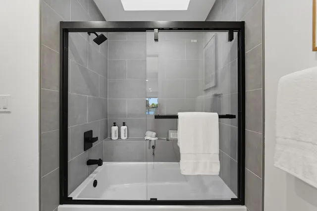 a bathroom with a granite countertop sink mirror and vanity