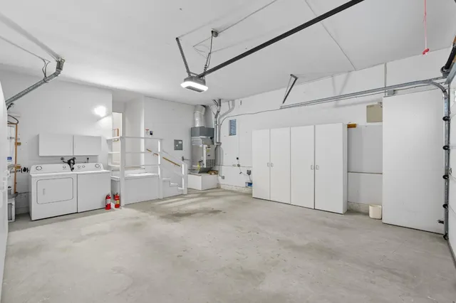 a view of roof deck with two chairs and a potted plant
