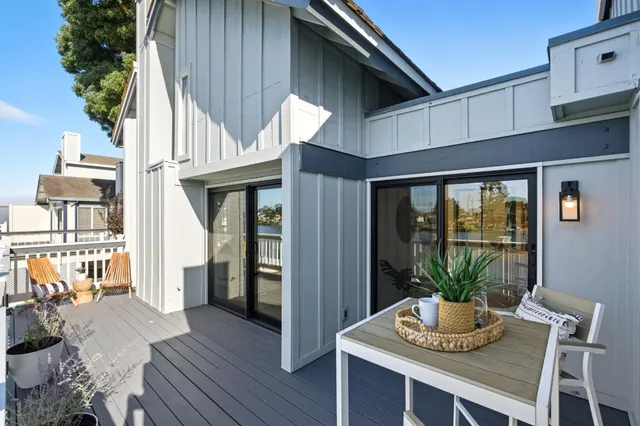 a view of a lake with wooden deck and city view