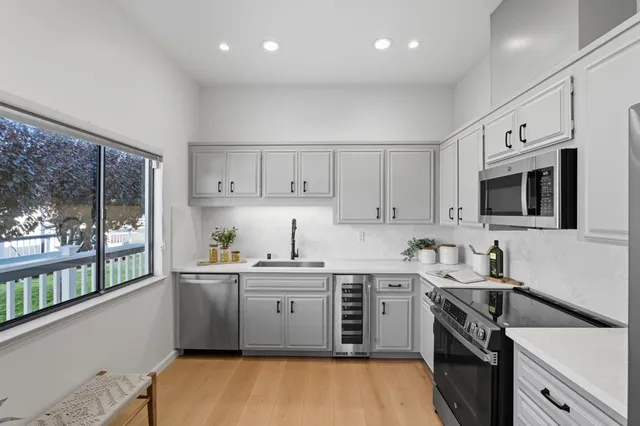 a kitchen that has a sink and a stove in it