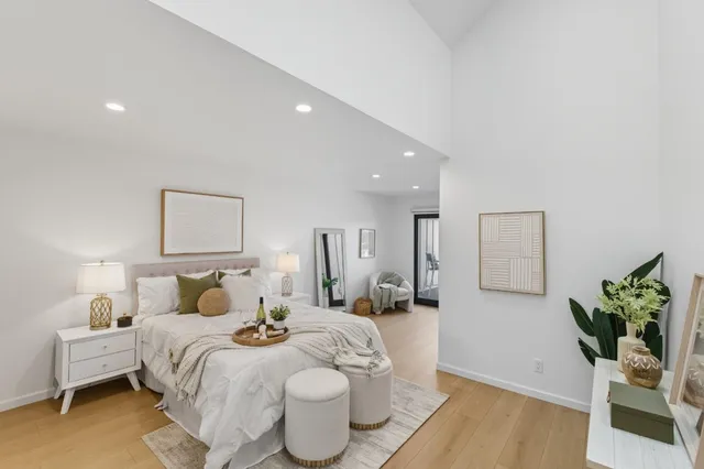 a bedroom with a bed and wooden floor