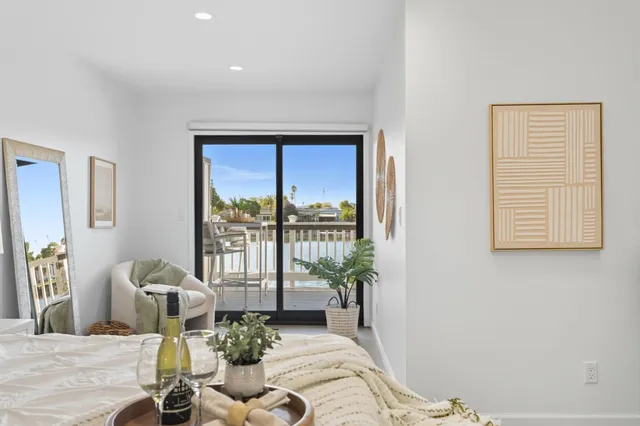 a living room with furniture large window and wooden floor