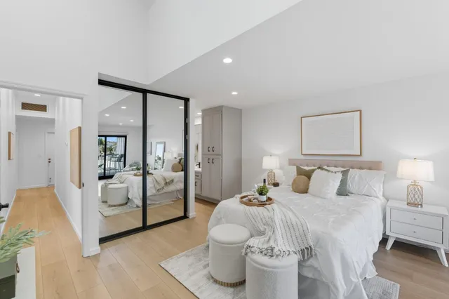 a bedroom with a white bed and white walls