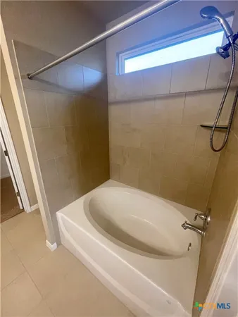 a bathroom with a bathtub and shower