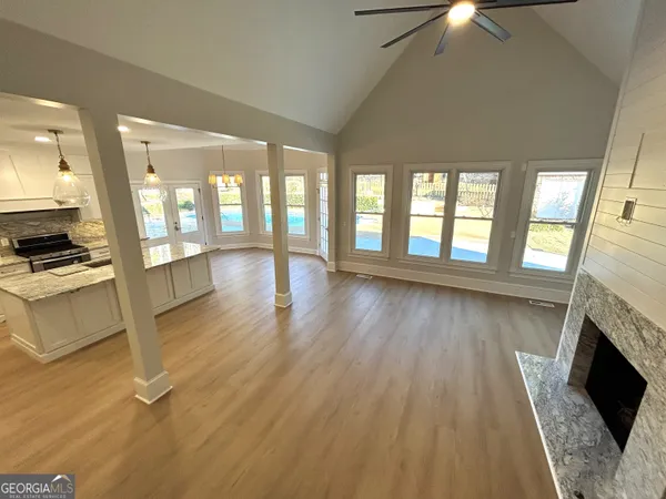 a view of a hallway with wooden floor and staircase