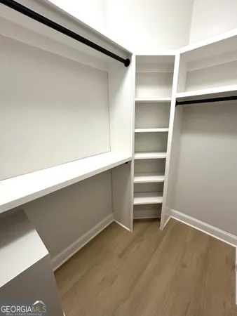 a bathroom with a double vanity sink a mirror and a shower