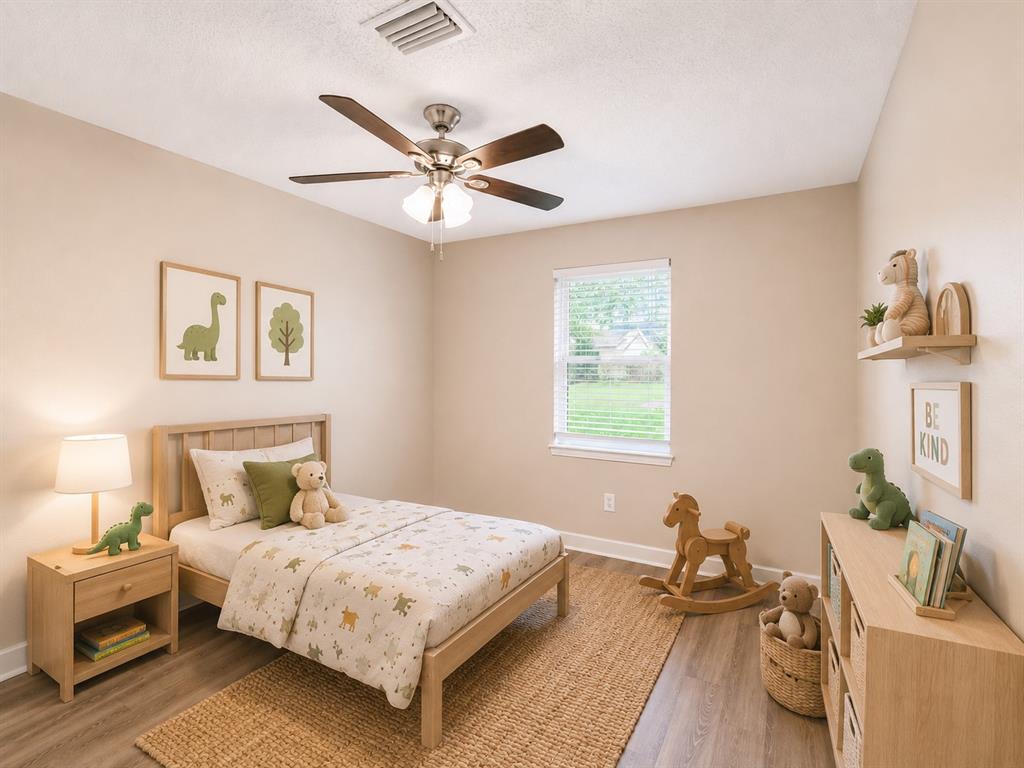 1231 Rutherford Drive Mesquite, TX 75149 - Photo 17 of 29 a bedroom with a bed and a chandelier
