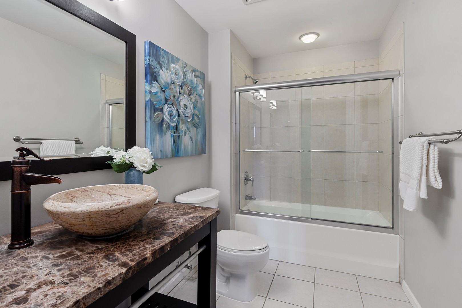 4848 North Sheridan Road, Unit 809 Chicago, IL 60640 - Photo 17 of 45 a spacious bathroom with a granite countertop sink a toilet a mirror and shower