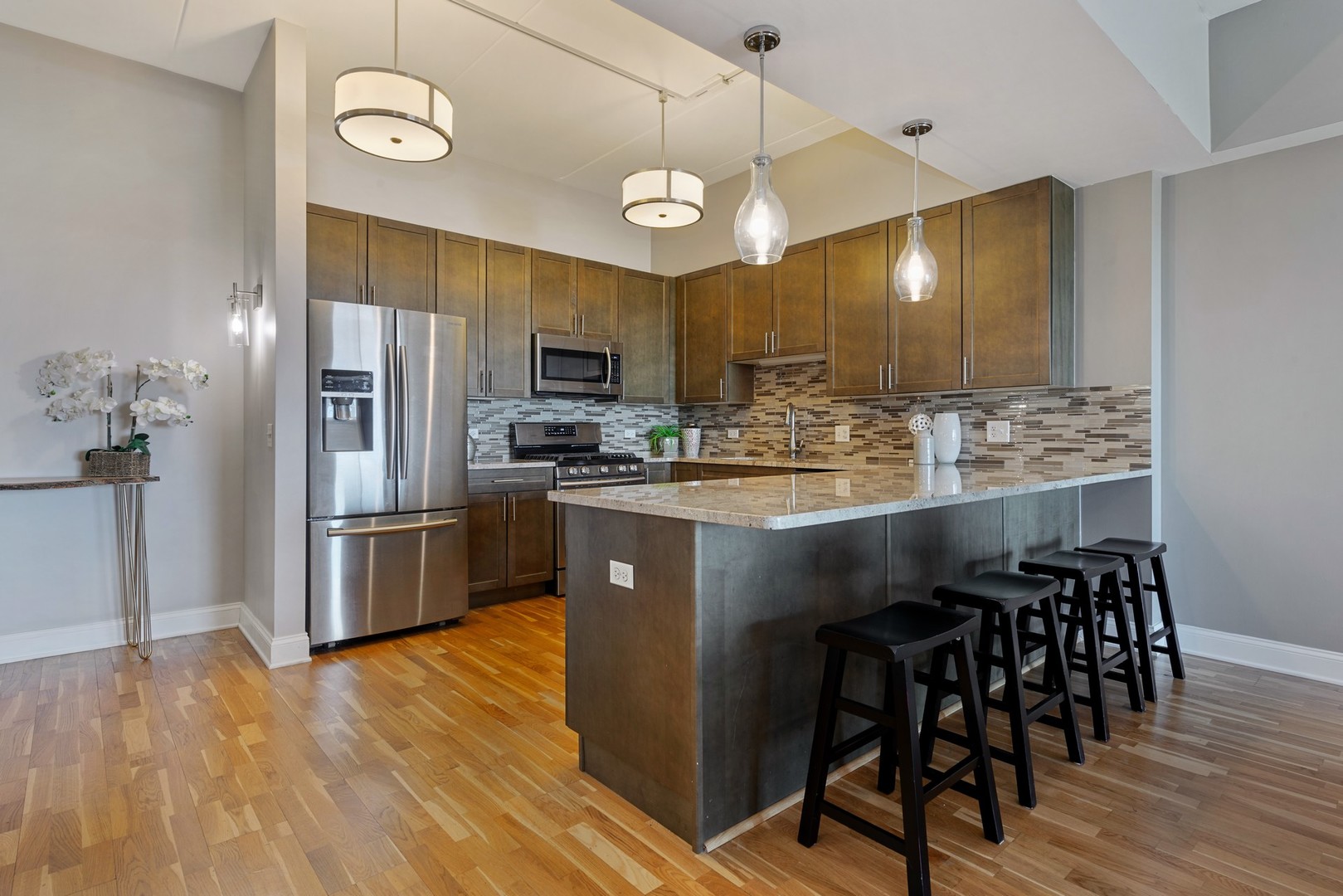 4848 North Sheridan Road, Unit 809 Chicago, IL 60640 - Photo 5 of 45 a kitchen with stainless steel appliances granite countertop a sink a stove a refrigerator cabinets and chairs