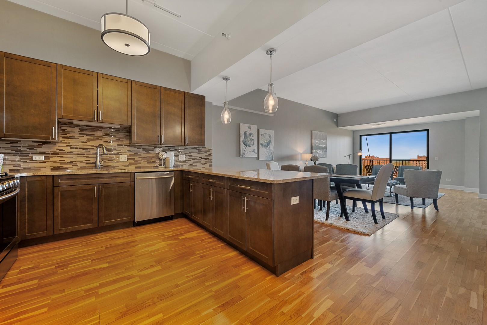 4848 North Sheridan Road, Unit 809 Chicago, IL 60640 - Photo 6 of 45 a kitchen with stainless steel appliances granite countertop a sink cabinets a dining table and chairs