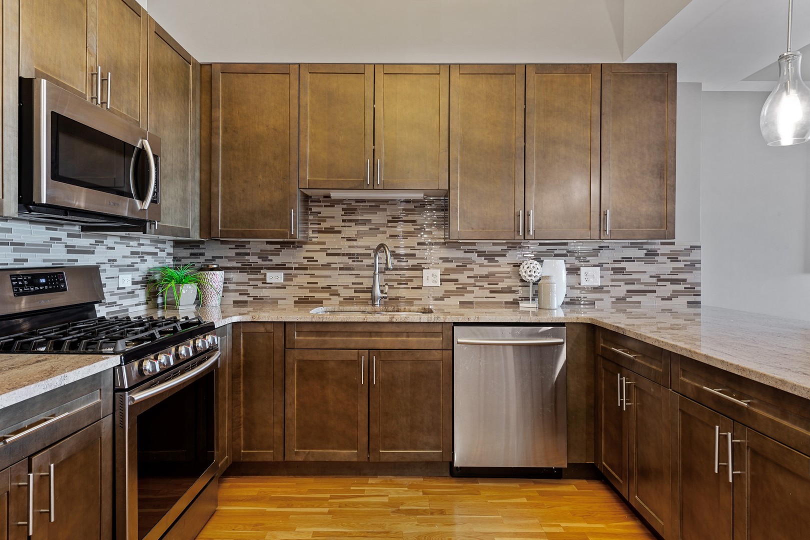 4848 North Sheridan Road, Unit 809 Chicago, IL 60640 - Photo 7 of 45 a kitchen with stainless steel appliances granite countertop a stove a sink and a microwave