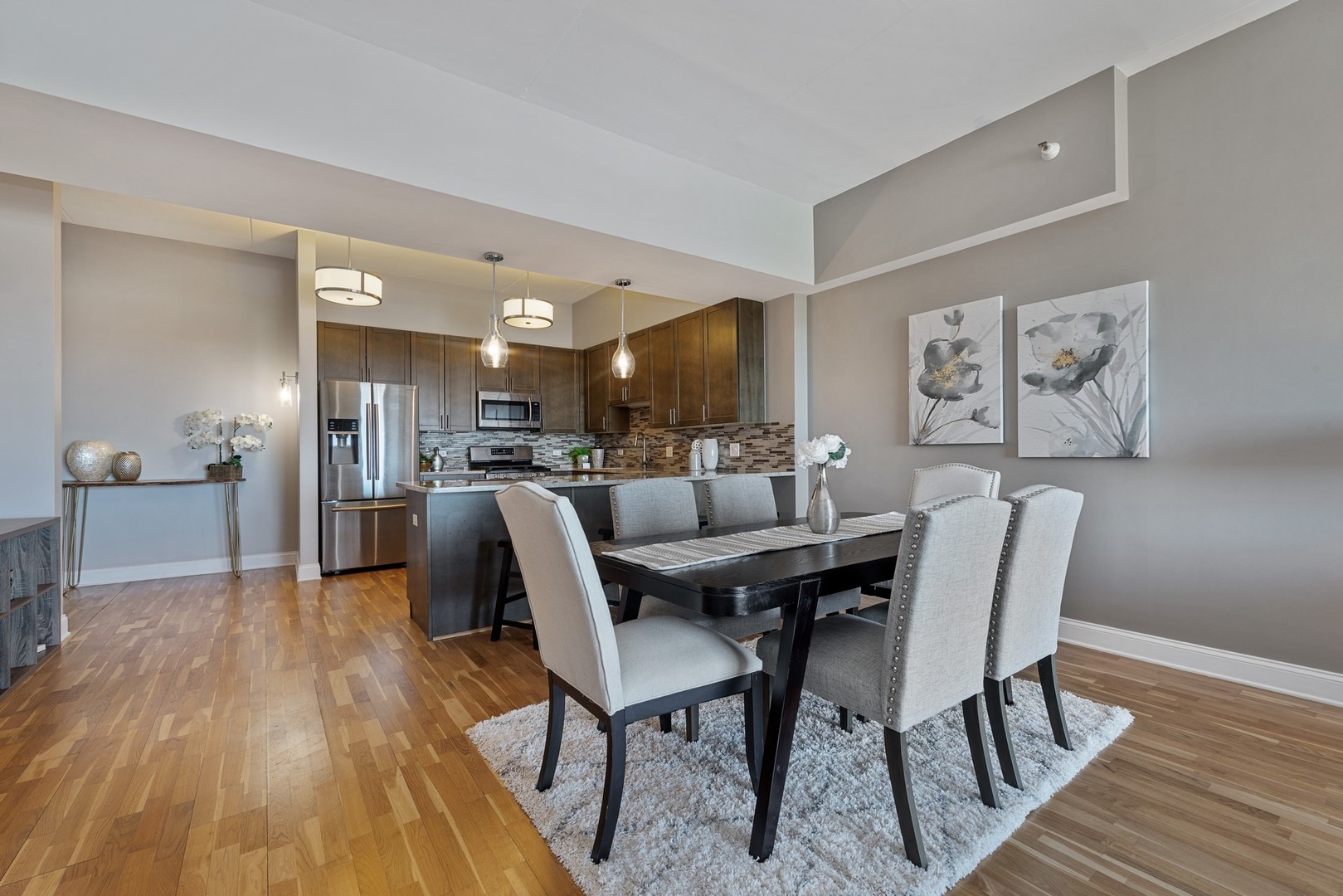 4848 North Sheridan Road, Unit 809 Chicago, IL 60640 - Photo 10 of 45 a view of a dining room with furniture and wooden floor