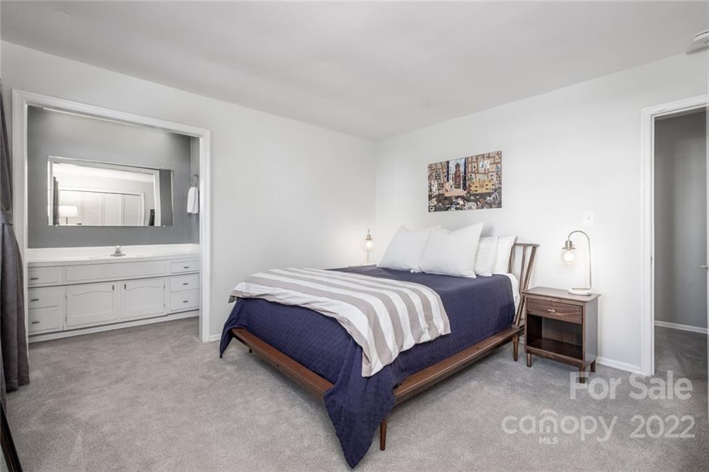 8346 Knights Bridge Road Charlotte, NC 28210 - Photo 11 of 29 a spacious bedroom with a bed and a table