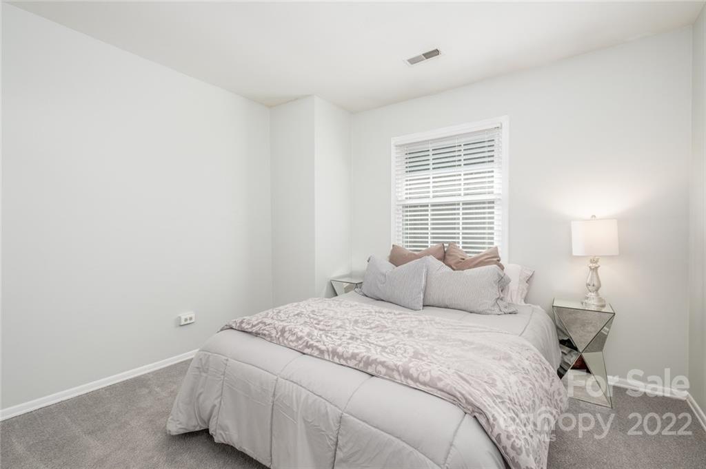 8346 Knights Bridge Road Charlotte, NC 28210 - Photo 14 of 29 a bedroom with a bed and a window