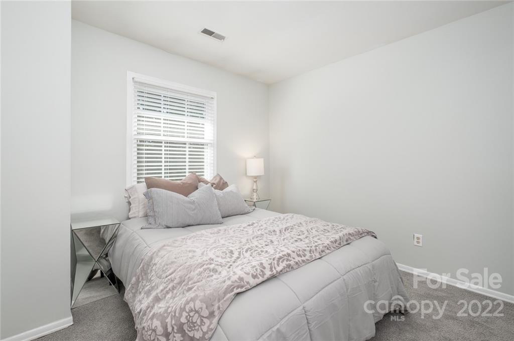 8346 Knights Bridge Road Charlotte, NC 28210 - Photo 15 of 29 a bedroom with a bed and a window