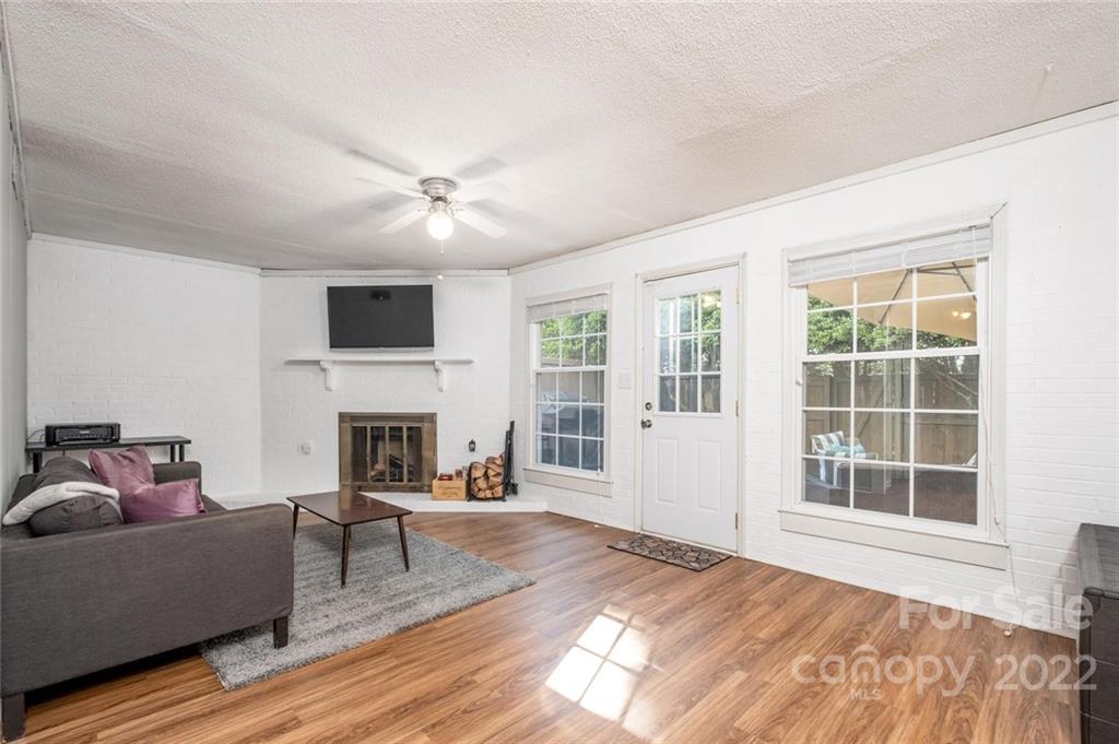 8346 Knights Bridge Road Charlotte, NC 28210 - Photo 20 of 29 a living room with furniture and a fireplace