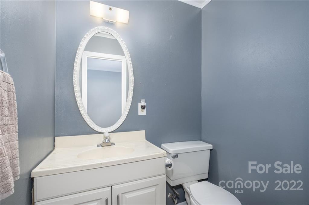8346 Knights Bridge Road Charlotte, NC 28210 - Photo 21 of 29 a bathroom with a toilet a sink and mirror