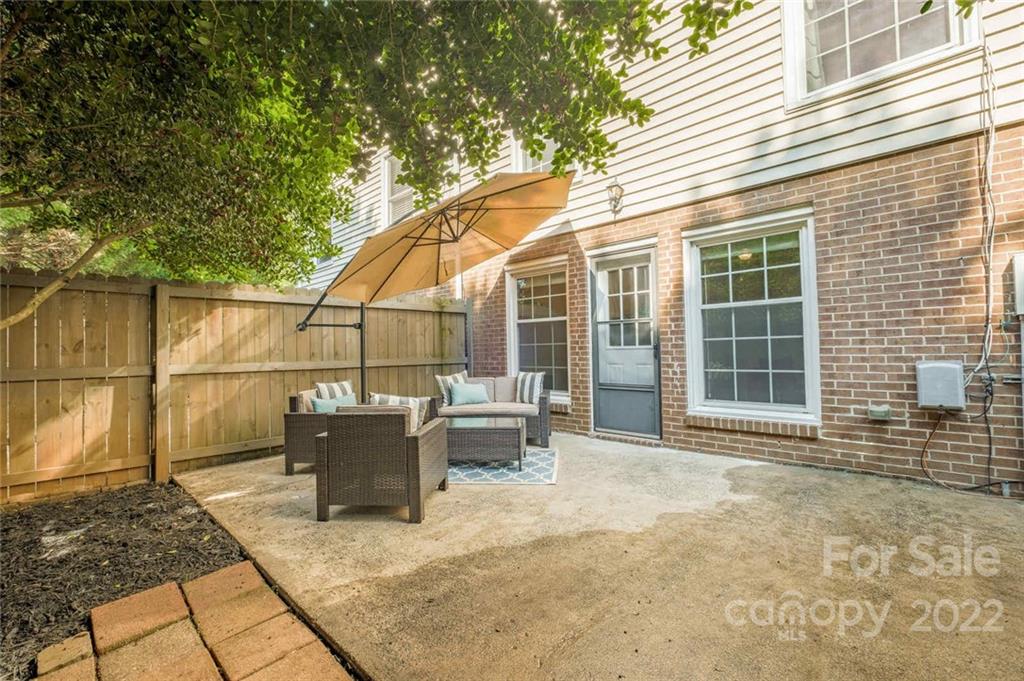 8346 Knights Bridge Road Charlotte, NC 28210 - Photo 22 of 29 a view of a patio with couches and potted plants