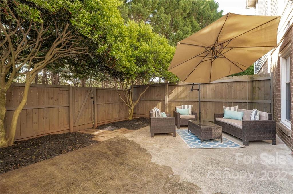 8346 Knights Bridge Road Charlotte, NC 28210 - Photo 23 of 29 a backyard of a house with sofas fire pit and furniture