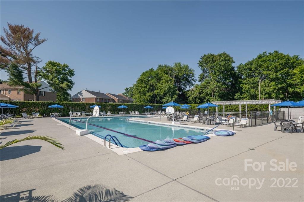 8346 Knights Bridge Road Charlotte, NC 28210 - Photo 25 of 29 a view of a swimming pool with a patio and a yard
