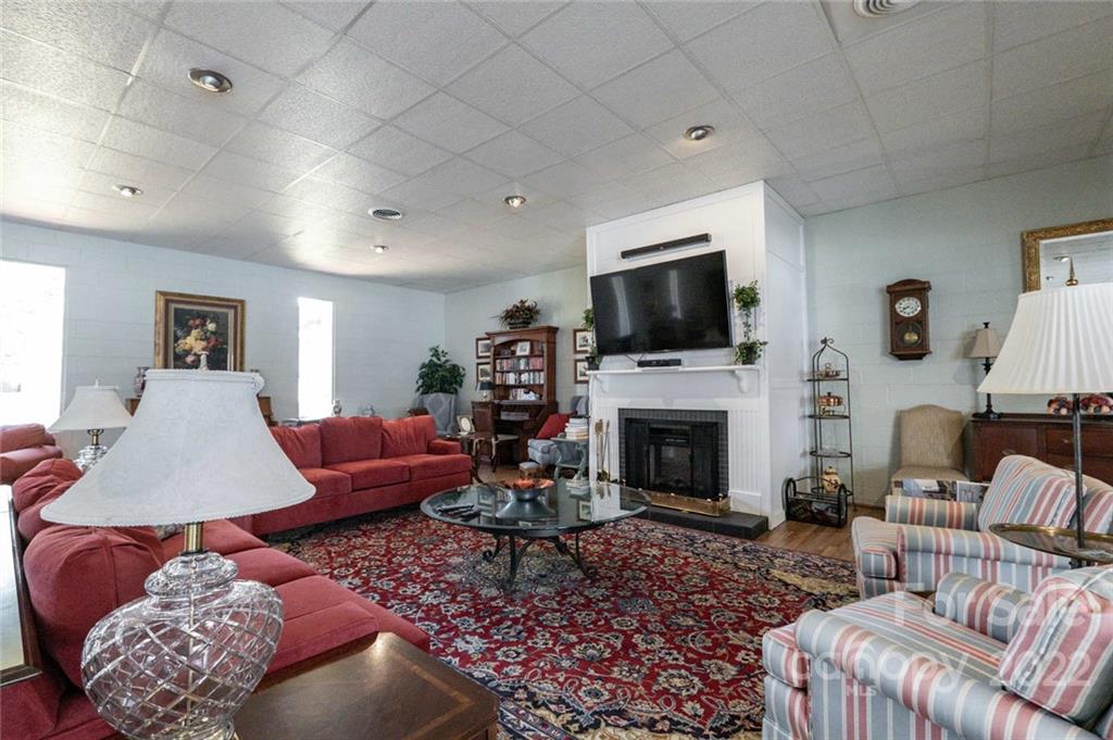 8346 Knights Bridge Road Charlotte, NC 28210 - Photo 29 of 29 a living room with furniture a fireplace and a flat screen tv