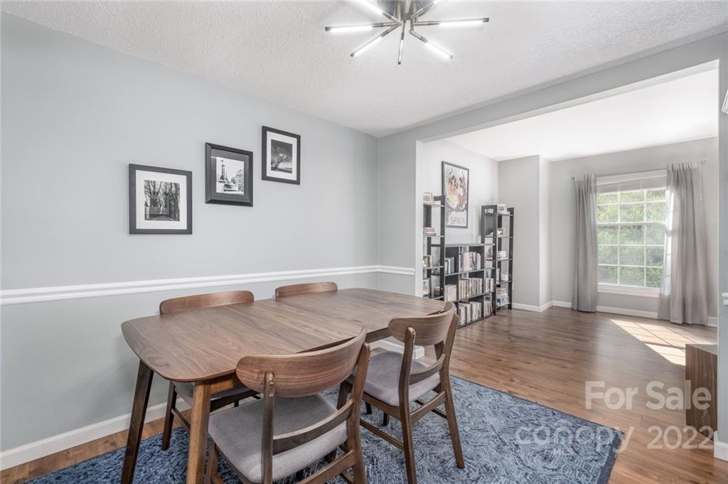 8346 Knights Bridge Road Charlotte, NC 28210 - Photo 5 of 29 a view of a dining room with furniture and wooden floor